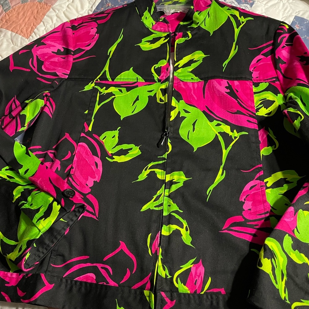 Mirette brand floral jacket on black background. Good condition. Size Medium.